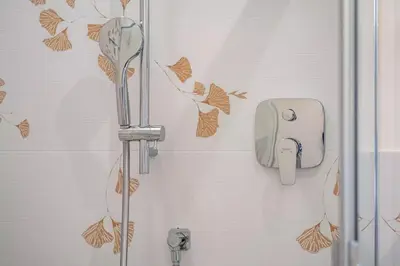 a shower in a bathroom with a towel dispenser at Nofnerhof in Appiano sulla Strada del Vino