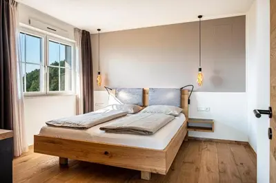a bedroom with a bed in a room with a window at Nofnerhof in Appiano sulla Strada del Vino