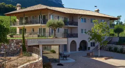 a large building with a courtyard in front at Nofnerhof in Appiano sulla Strada del Vino