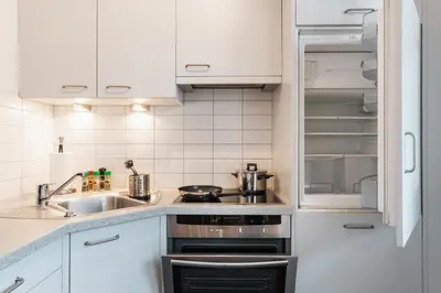 a kitchen with a sink and an open refrigerator at FaWa Apartments 