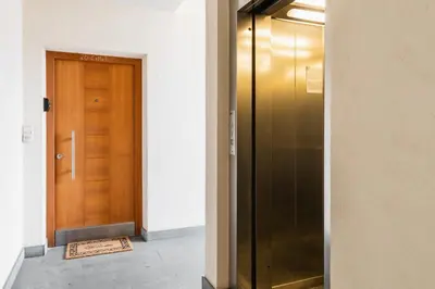 a wooden door in a hallway with a mat next to it at FaWa Apartments 
