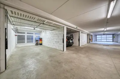 an empty garage with a car parked in it at FaWa Apartments 