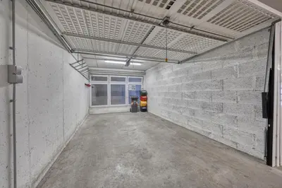 an empty garage with a brick wall at FaWa Apartments 