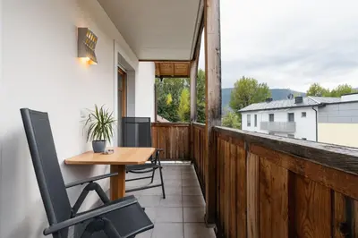 a balcony with a wooden fence and a table and chairs at FaWa Apartments 