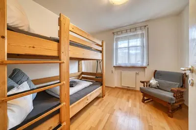 a bedroom with two bunk beds and a chair at FaWa Apartments 