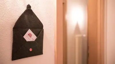 a black bag hanging on a wall next to a door at Residence Ciasa Vedla in Badia