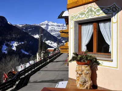 a building with a window with a view of a mountain at Hotel Cesa Padon in Arabba