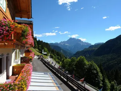 a view of the mountains from the balcony of a building at Hotel Cesa Padon in Arabba