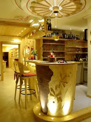 a kitchen with a counter with a bar in it at Hotel Cesa Padon in Arabba