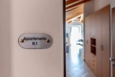 a door with a sign that reads apparatusmitemitemitemn at Appartamento alla Brisa Grauno Ospitar in Grauno