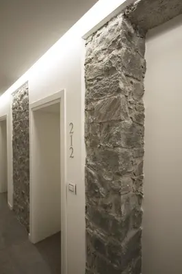 a stone wall in a hallway with a number on it at Hotel Venezia in Rocca Pietore