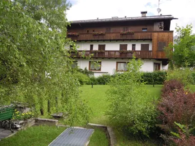 a bedroom with a bed in a room with wooden walls at Hotel Principe in Cortina dʼAmpezzo