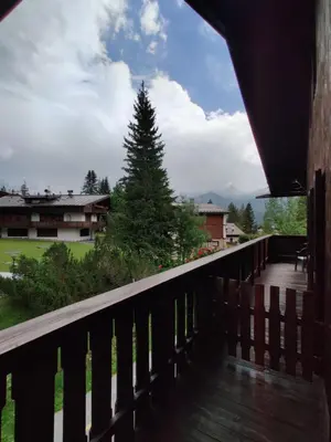 a bedroom with a bed and a table and chairs at Hotel Principe in Cortina dʼAmpezzo