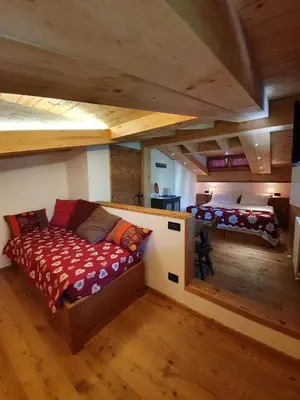 an attic bedroom with two beds in a room at B&B Cristallo in Cortina dʼAmpezzo