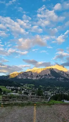 a view of a city with mountains in the background at B&B Cristallo in Cortina dʼAmpezzo