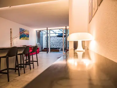 a dining room and living room with a table and chairs at Sweet Piccolo in Merano
