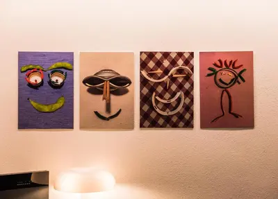 a group of paintings on a wall at Sweet Piccolo in Merano