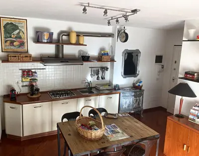 a kitchen with a table with a basket on it at Living Rencio: vicino al Centro di Bolzano in Bolzano