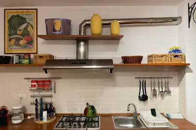 a kitchen counter with a sink and a stove at Living Rencio: vicino al Centro di Bolzano in Bolzano