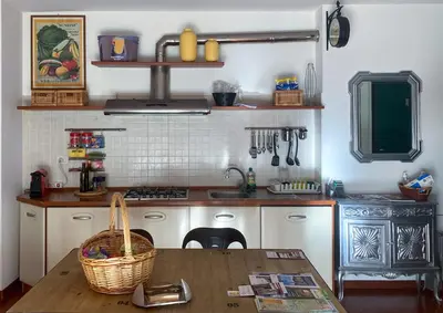 a kitchen with a wooden table and a sink at Living Rencio: vicino al Centro di Bolzano in Bolzano