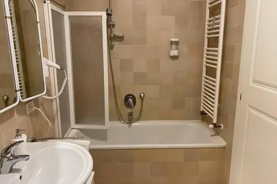 a bathroom with a shower and a tub and a sink at Living Rencio: vicino al Centro di Bolzano in Bolzano