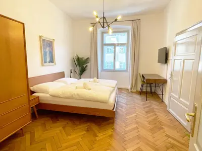 a bedroom with a bed and a window at Rosa Apartments City Center in Merano