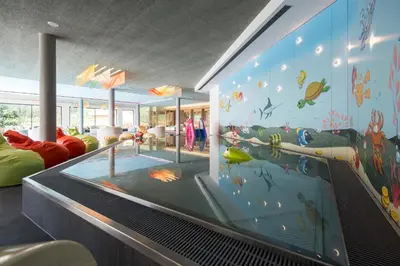 a room with a large aquarium in the middle of the room at Familienhotel Huber in Valles