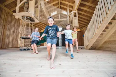a group of children running on a gym at Familienhotel Huber in Valles