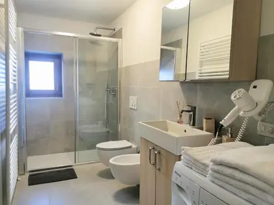 a bathroom with a toilet and a sink and a shower at Cesa da Riz in Colle Santa Lucia