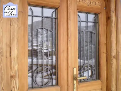 a wooden door with two windows and a sign on it at Cesa da Riz in Colle Santa Lucia