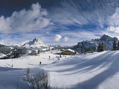 a group of people skiing down a snow covered mountain at Cesa da Riz in Colle Santa Lucia