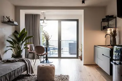 a living room with a bed and a dining table at My Spring - Panoramic Suites in Lana