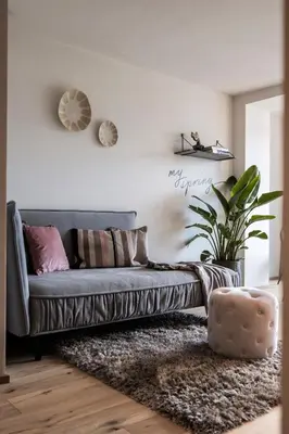 a living room with a blue couch and a plant at My Spring - Panoramic Suites in Lana