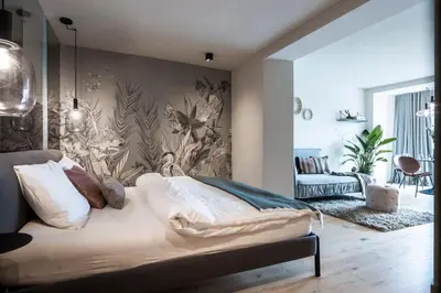 a bedroom with a bed with a wall mural at My Spring - Panoramic Suites in Lana