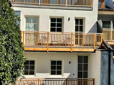 a building with a deck on the side of it at Rosa's Boutique Apartment in Merano