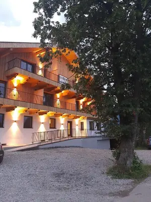 a large building with a tree in front of it at Appartments Lindenhof in Riscone