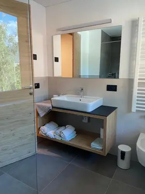 a bathroom with a sink and a mirror at Appartments Lindenhof in Riscone