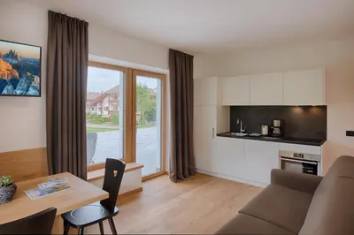 a living room with a couch and a table at Appartments Lindenhof in Riscone