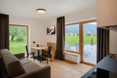 a living room with a couch and a table at Appartments Lindenhof in Riscone