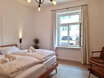 a bedroom with a bed and a window at Rosa Rooms Meran in Merano