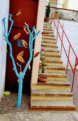 a set of stairs with a blue tree on it at Rosa Rooms Meran in Merano