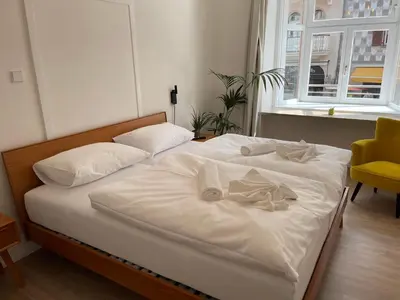 a bedroom with two beds with white sheets and pillows at Rosa Rooms Meran in Merano