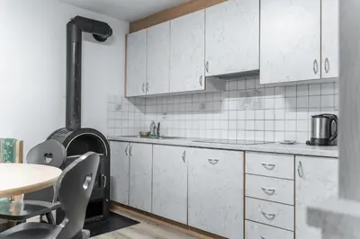 a kitchen with white cabinets and a stove at La ciasota in Antermoia