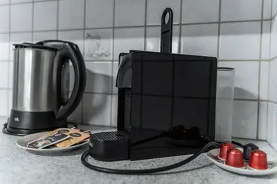 a kitchen counter with a coffee maker and a microwave at La ciasota in Antermoia