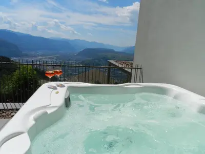 a hot tub on a balcony with a view at Noan Panorama Suiten - Arendt in San Genesio Atesino