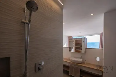 a bathroom with a shower with a sink and a mirror at Noan Panorama Suiten - Arendt in San Genesio Atesino