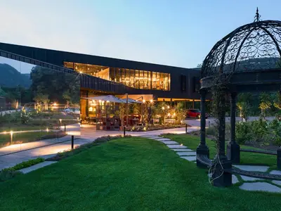 a building with a gazebo in front of it at Manna Resort in Montagna