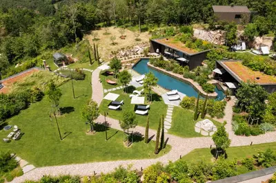 an aerial view of a house with a garden at Manna Resort in Montagna