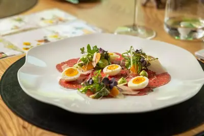 a plate of food with eggs on a table at Manna Resort in Montagna
