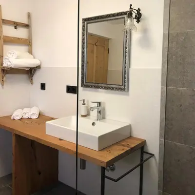 a bathroom with a white sink and a mirror at Ringgelinhof Onach in San Lorenzo di Sebato